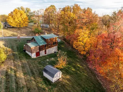 an aerial view of a house in the woods at Maple Leaf Cabin in Millersburg