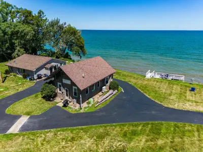 an aerial view of a house on the water at Cozy Lakefront Cottage in Huron