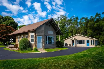 a small house on a street at Cozy Lakefront Cottage in Huron