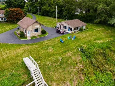 an aerial view of a house and a yard at Cozy Lakefront Cottage in Huron