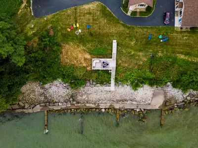 an overhead view of a house on a island in the water at Cozy Lakefront Cottage in Huron