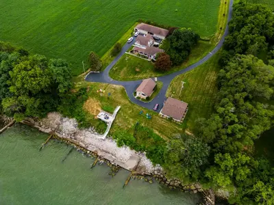 an aerial view of a house on a island in the water at Cozy Lakefront Cottage in Huron