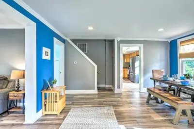 a dining room with blue walls and a dining table at Sweetwater Hideaway - Blocks to Lake Erie! in Port Clinton
