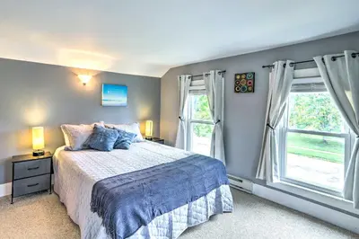 a bedroom with a bed and two windows at Sweetwater Hideaway - Blocks to Lake Erie! in Port Clinton
