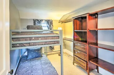 a room with two bunk beds and a dresser at Sweetwater Hideaway - Blocks to Lake Erie! in Port Clinton