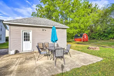 a patio with a table and chairs and an umbrella at Sweetwater Hideaway - Blocks to Lake Erie! in Port Clinton