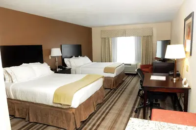 a hotel room with two beds and a desk at Holiday Inn Express & Suites Cambridge by IHG in Cambridge
