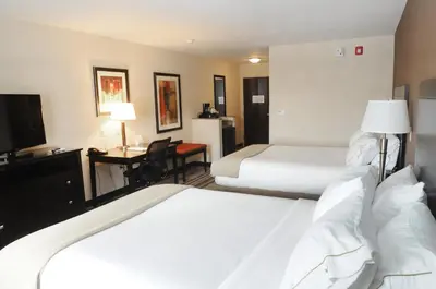 a hotel room with two beds and a desk at Holiday Inn Express & Suites Cambridge by IHG in Cambridge