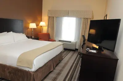 a hotel room with a bed and a flat screen tv at Holiday Inn Express & Suites Cambridge by IHG in Cambridge