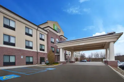 a hotel with a parking lot in front of a building at Holiday Inn Express & Suites Washington - Meadow Lands by IHG in Washington