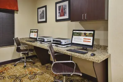 a hotel room with two computers on a desk at Holiday Inn Express & Suites Washington - Meadow Lands by IHG in Washington