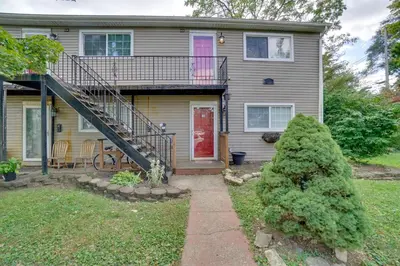 a house with a red door and a staircase at Dtwn Columbus Getaway Pet Friendly with Fee! in Columbus