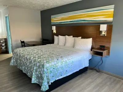 a bed in a hotel room with a large bed sidx sidx sidx at HomeTowne Studios by Red Roof Georgetown, KY in Georgetown