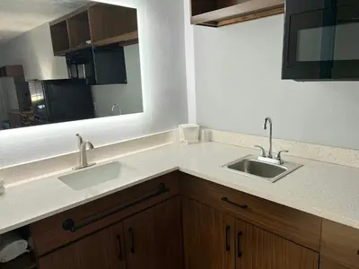 a bathroom with two sinks and a mirror at HomeTowne Studios by Red Roof Georgetown, KY in Georgetown
