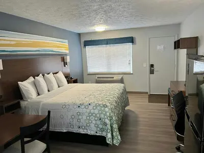 a bedroom with a bed and a table and a window at HomeTowne Studios by Red Roof Georgetown, KY in Georgetown