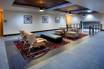 a lobby with a waiting area with chairs and a couch at Four Points by Sheraton Charleston in Charleston