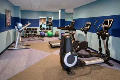 a gym with several cardio machines in a room at Four Points by Sheraton Charleston in Charleston