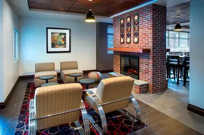 a waiting room with chairs and a fireplace at Four Points by Sheraton Charleston in Charleston