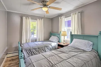 a bedroom with two beds and a ceiling fan at Lakefront Cottage with Fishing and Private Yard! in Port Clinton