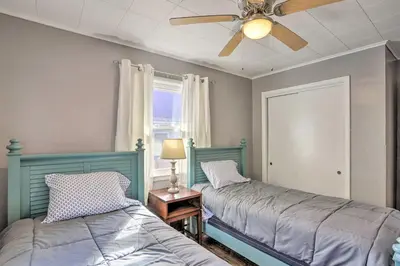 a bedroom with two beds and a ceiling fan at Lakefront Cottage with Fishing and Private Yard! in Port Clinton