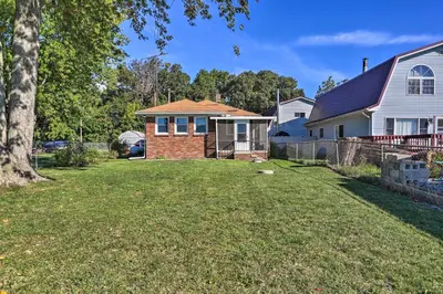 a home with a yard in front of a house at Lakefront Cottage with Fishing and Private Yard! in Port Clinton