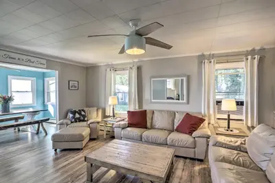 a living room with a couch and a table at Lakefront Cottage with Fishing and Private Yard! in Port Clinton