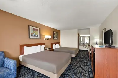 a hotel room with a bed and a television at Americas Best Value Inn-Celina in Celina