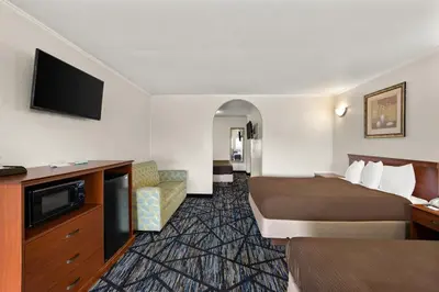 a hotel room with a bed and a flat screen tv at Americas Best Value Inn-Celina in Celina