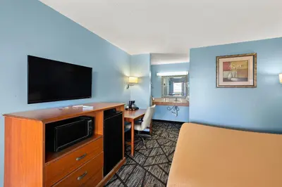 a hotel room with a flat screen tv at Americas Best Value Inn-Celina in Celina