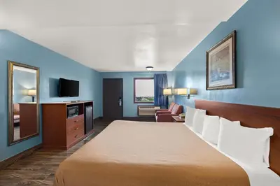 a hotel room with a bed and a television at Americas Best Value Inn-Celina in Celina