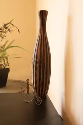 a vase sitting on a table next to a small bike at Biker Hiker friendly 3 bedroom by Strouds Run State Park in Athens