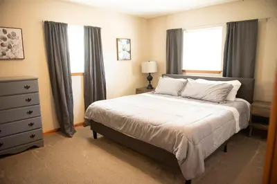 a bedroom with a large bed and a window at Biker Hiker friendly 3 bedroom by Strouds Run State Park in Athens