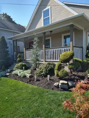 a house with a front porch with landscaping at Family Friendly JUST LIKE HOME in Cleveland