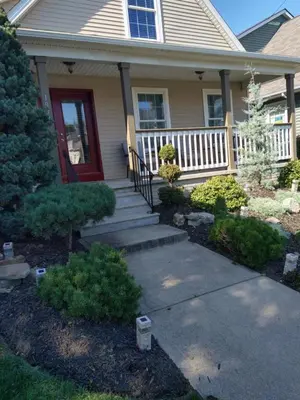 a house with a red door and a porch at Family Friendly JUST LIKE HOME in Cleveland