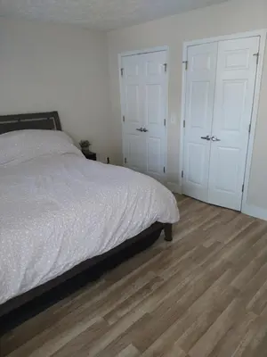 a bedroom with a bed and two white doors at Family Friendly JUST LIKE HOME in Cleveland