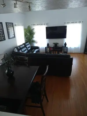 a living room with a couch and a table at Family Friendly JUST LIKE HOME in Cleveland