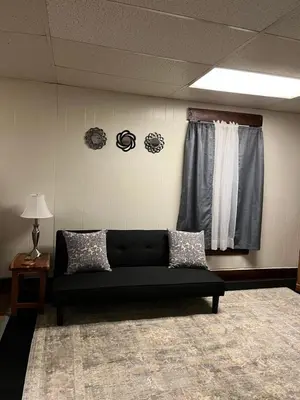 a black couch in a room with a window at Cherry712upstairs in Fairborn