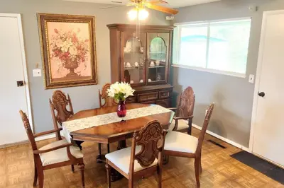 a dining room with a table and chairs at Cheerful 3-BR home near Downtown Dayton, Wright Patterson AFB and Airport in Dayton