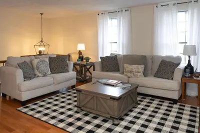a living room with two couches and a coffee table at Sleeps 12, Wooded Lot, Near Ark, Great for Family in Williamstown