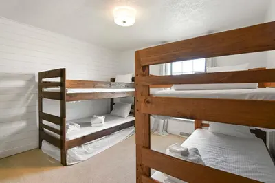 a room with two bunk beds in a house at Sleeps 12, Wooded Lot, Near Ark, Great for Family in Williamstown