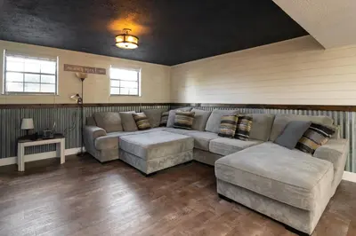 a large living room with a couch and a table at Sleeps 12, Wooded Lot, Near Ark, Great for Family in Williamstown