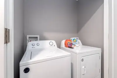 a white washer and dryer in a laundry room at Soaring 2-Bedroom Parkside Loft Walkable to it All in Cincinnati