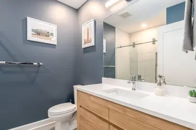 a bathroom with a white sink and a toilet at Soaring 2-Bedroom Parkside Loft Walkable to it All in Cincinnati