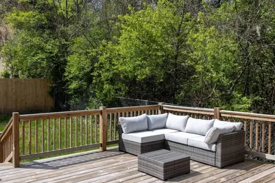 a wooden deck with a couch on top of it at Deluxe 4-Bedroom w Huge Deck 3-Min to Downtown in Cincinnati