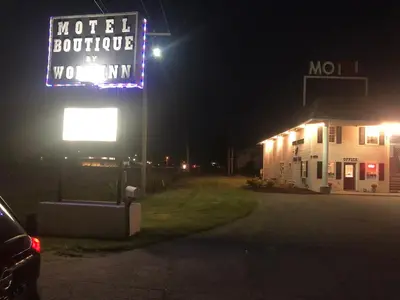 a motel sign next to a building at night at Motel Boutique by Wolf Inn in Milan