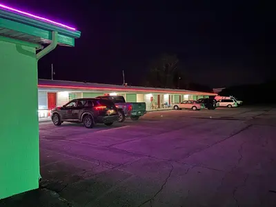 a car parked in a parking lot in front of a building at Motel Boutique by Wolf Inn in Milan