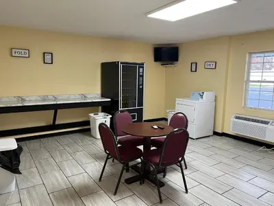a room with a table and chairs and a kitchen at Motel Boutique by Wolf Inn in Milan