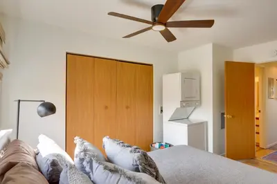 a bedroom with a couch and a ceiling fan at Pet-Friendly Oak Harbor Condo Walk to Lake! in Sand Beach