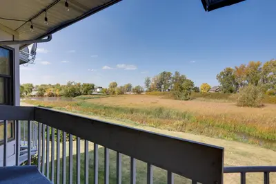 a view of a field from the porch of a house at Pet-Friendly Oak Harbor Condo Walk to Lake! in Sand Beach