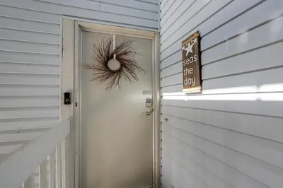 a wreath is on the door of a house at Pet-Friendly Oak Harbor Condo Walk to Lake! in Sand Beach